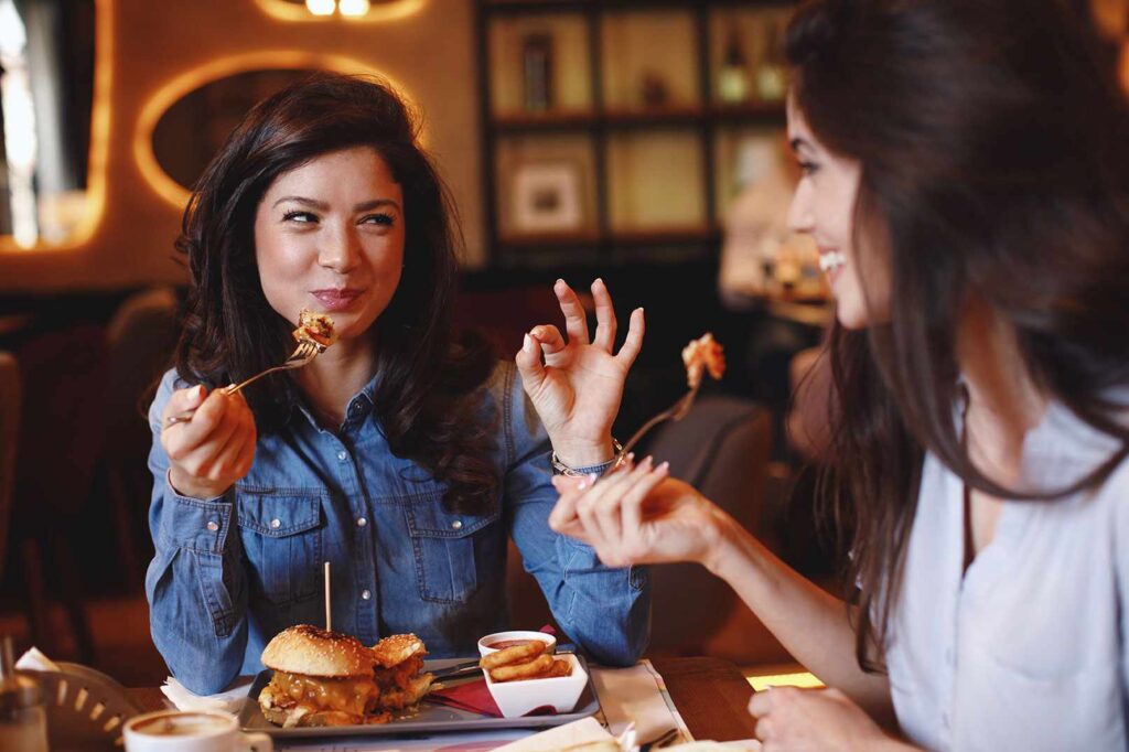 Two women eating food together